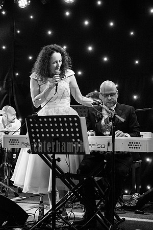 Romantice wedding -Surrey wedding photographer/ Braid and groom plating music at the wedding party - black and white photography