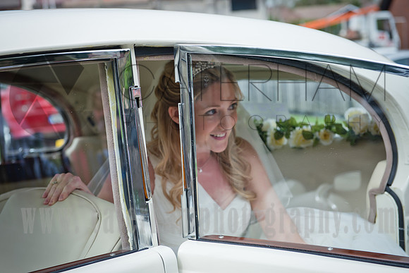Surrey wedding photographer sacred heart church caterham/ The Bride coming out of the wedding car
