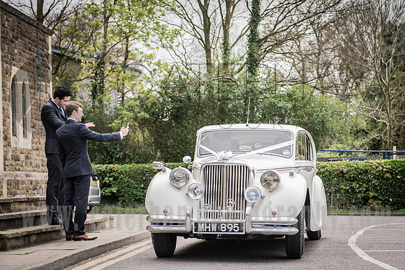 sacred heart church caterham / Guests taking photos of the new married couple