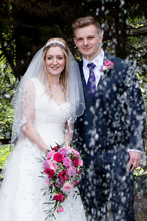 Surrey wedding photographer / oaks farm wedding (4) / The wedding couple by the trees and fountain
