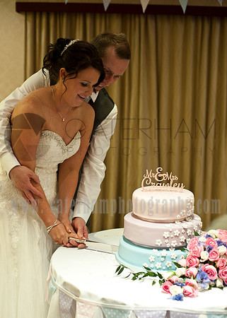 Surrey wedding photographer : Bride and groom cutting the wedding cake Legacy Thatchers Hotel Wedding