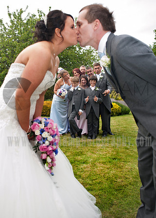 Surrey wedding photographer /Legacy Thatchers Hotel Wedding the archway kiss (14)