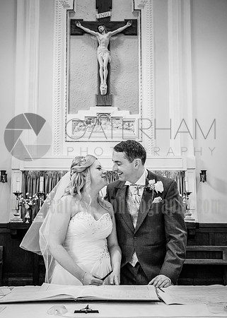 surrey wedding phtotgrapher-holy Cross Church in Carshalton- bride and groom kissing