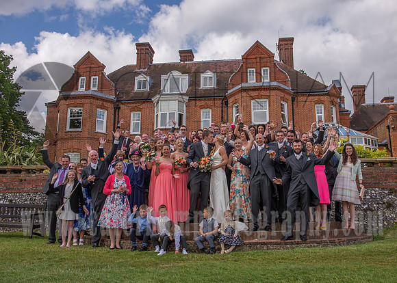 Surrey wedding photographer / Tyrrells Wood Golf Club Wedding / Wedding group photo / Groom and bride kiss / Wedding couple with guests