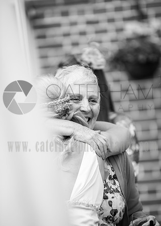 Surrey wedding photographer / Tyrrells Wood Golf Club Wedding /  The bride hugging grooms mum / Wedding photography
