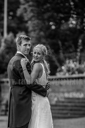 Surrey wedding photographer / Tyrrells Wood Golf Club Wedding /  The bride and the groom hug /Black and white wedding photography