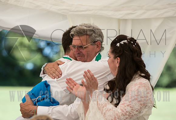Surrey wedding photographer / marquee wedding (4) / Wedding guests hug