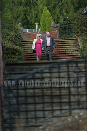 Surrey Wedding Photographer / woldingham school wedding / Parents waling down the stairs / Guests at the wedding
