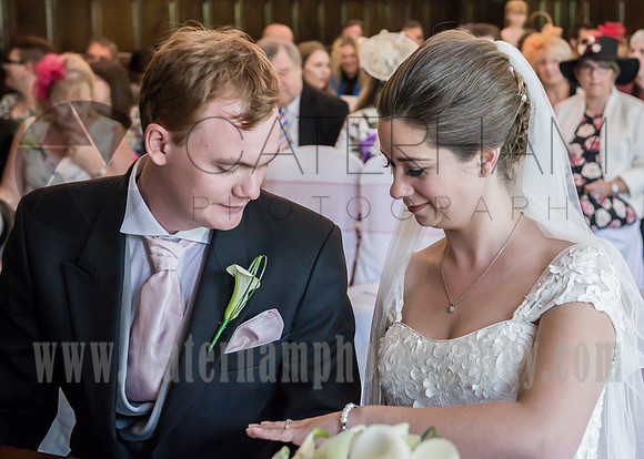 Surrey wedding photographer / Mansion Wedding (15) / The wedding couple at the altar / Wedding couple looking at wedding ring