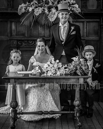 Surrey wedding photographer / Mansion Wedding (17) /  The bride and groom by the table with kids