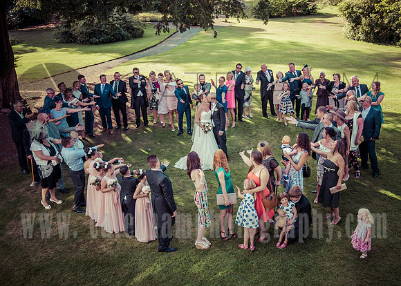 East Grinstead wedding photographers / yew lodge weddings /  Group photo / Guests in shape of heart / Fun and creative wedding photos