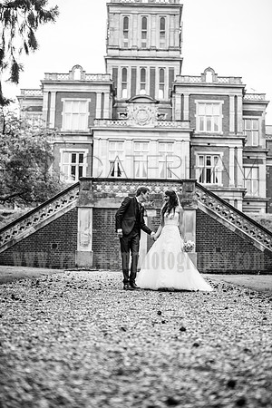 surrey wedding photographer- bride and groom walking away from venue