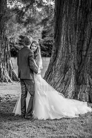Surrey wedding photographer- bride looking over grooms shoulder