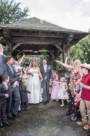 Kent wedding photography / St Mary's Church Ide Hill Wedding / Guests throwing flowers leaves at the new married couple