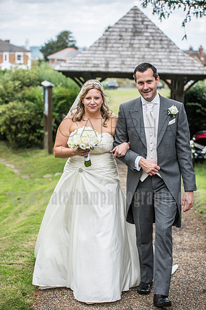Kent wedding photographer / St Mary's Church Ide Hill Wedding / The wedding couple walking up the pavement