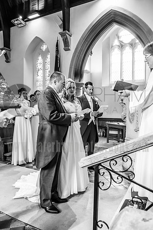 Kent wedding photography / St Mary's Church Ide Hill Wedding / The wedding couple singing at the altar