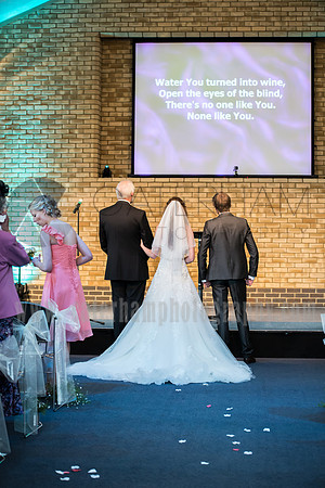 Surrey wedding photogrpher / reigate baptist church (25) / The bride and groom singing in the church during the wedding ceremony