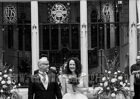 Surrey wedding photography / Wedding at St Paul’s Church in Addlestone / The groom and bride walking down the church aisle - close shoot