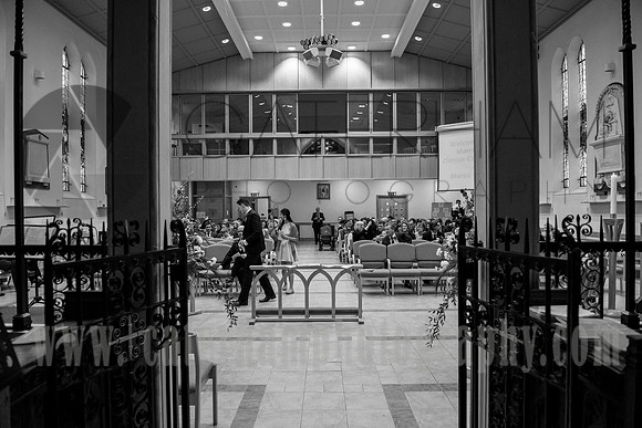 Surrey wedding photographer / Wedding at St Paul’s Church in Addlestone / Guests in the church form the front view