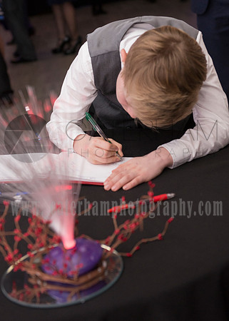 Surrey wedding photography / mercedes benz world weddings (1) / Little boy signing up on the guests list