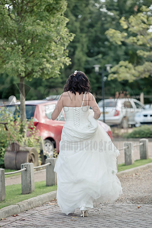Surrey wedding photographer / The Red Barn Wedding reception (7) / The bride from the back / Bride walking