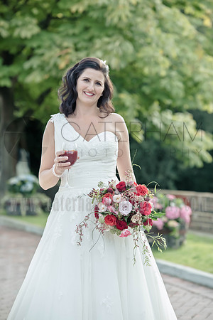 Surrey wedding photographer / The Red Barn Wedding reception (2) / The bride holding the bouquet and glass