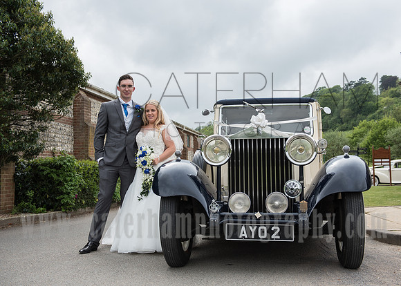 Surrey wedding photographer godstone church wedding Wedding couple next to the old style wedding car