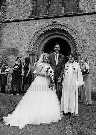 Surrey wedding photographer godstone church wedding New married couple with the priest after the ceremony