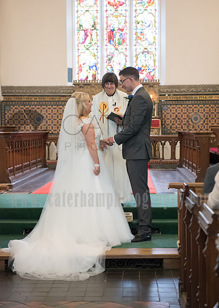 Surrey wedding photographer godstone church wedding Bride and Groom exchanging the rings