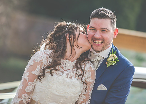 Surrey wedding photographer- westerham golf club wedding- bride kissing groom cheak
