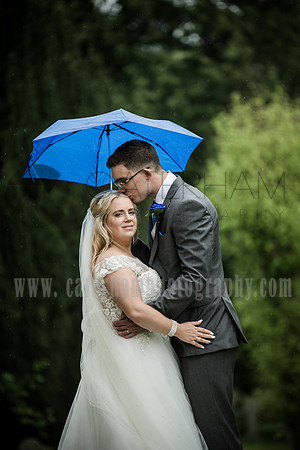 Surrey wedding photographer godstone church wedding New married forehead kiss under umbrealla