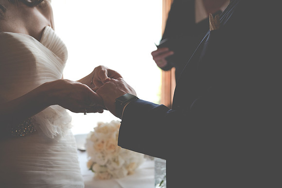 Surrey Wedding Photographer- Nutfield Priory- close up of the exchanging of the rings 16