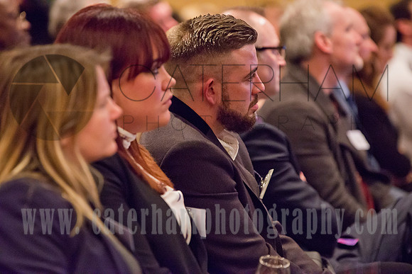 surrey event photographer-BNI event- men and women sitting together in business meeting
