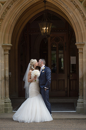 Surrey Wedding Photographer- Nutfield Priory doorway kiss 21
